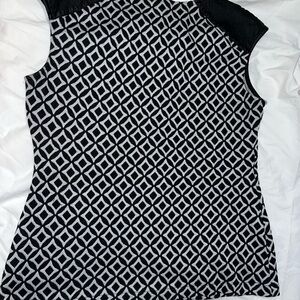 Black and white short sleeve top with leather like material on the shoulders